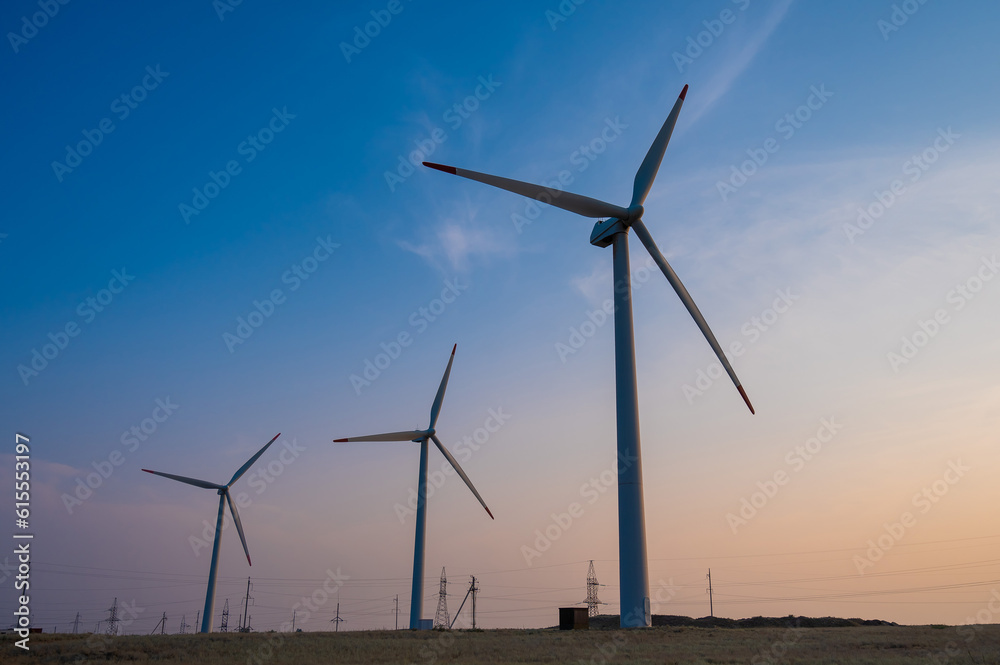 Windmills at sunset. Alternative energy source.