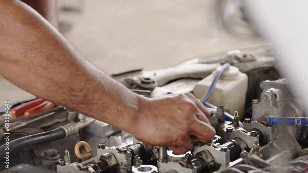 Auto mechanic repair engine in a car repair shop.Car engine repair. Car service Auto mechanic repair engine in a car repair shop.Car engine repair. Car service