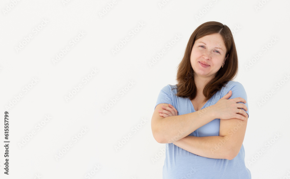 Photo of overjoyed pregnant lady good mood hands hug herself shoulders enjoy joyful smile wear blue t-shirt isolated white color background Photo of overjoyed pregnant lady good mood hands hug herself shoulders enjoy joyful smile wear blue t-shirt isolated white color background