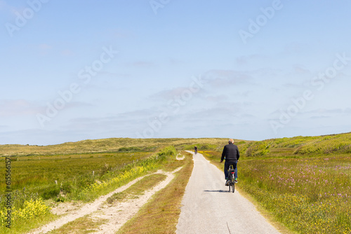 Fototapeta Naklejka Na Ścianę i Meble -  Tourist cycling at nature reserve Boschplaat at Wadden island Terschelling in Friesland province in The Netherlands