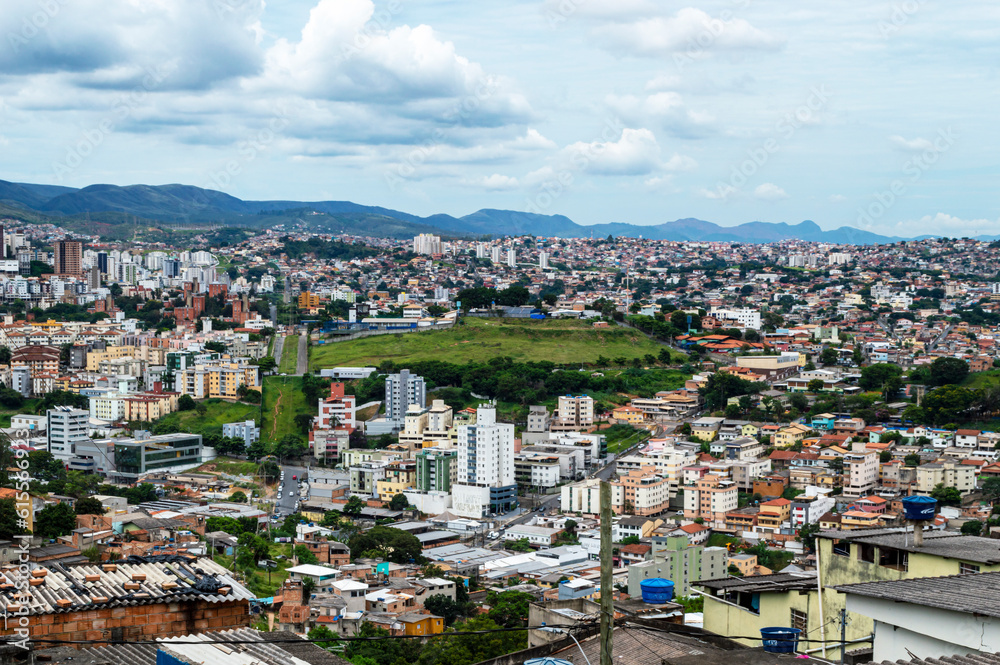 Panorama of the city of Belo Horizonte with a mountainous skyline. Cloudy sky. Various constructions.