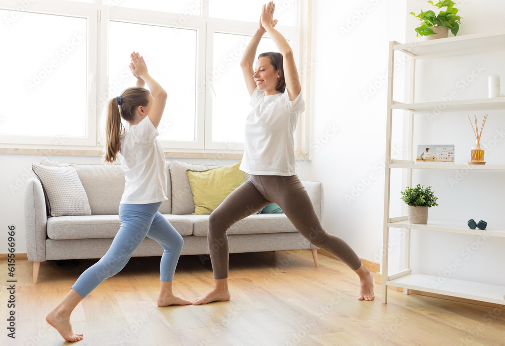 Practice yoga at home. Glad millennial caucasian woman in sportswear and teenage daughter, training