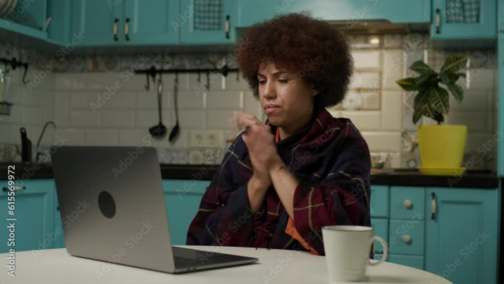 Woman Feeling Cold Working Online at Home. Black lady wrapped in plaid typing on laptop sitting in cold apartments. Lack of heating at home. Woman Feeling Cold Working Online at Home. Black lady wrapped in plaid typing on laptop sitting in cold apartments. Lack of heating at home.
