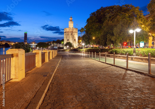 The golden tower of Torre del Oro in night illumination at sunset.