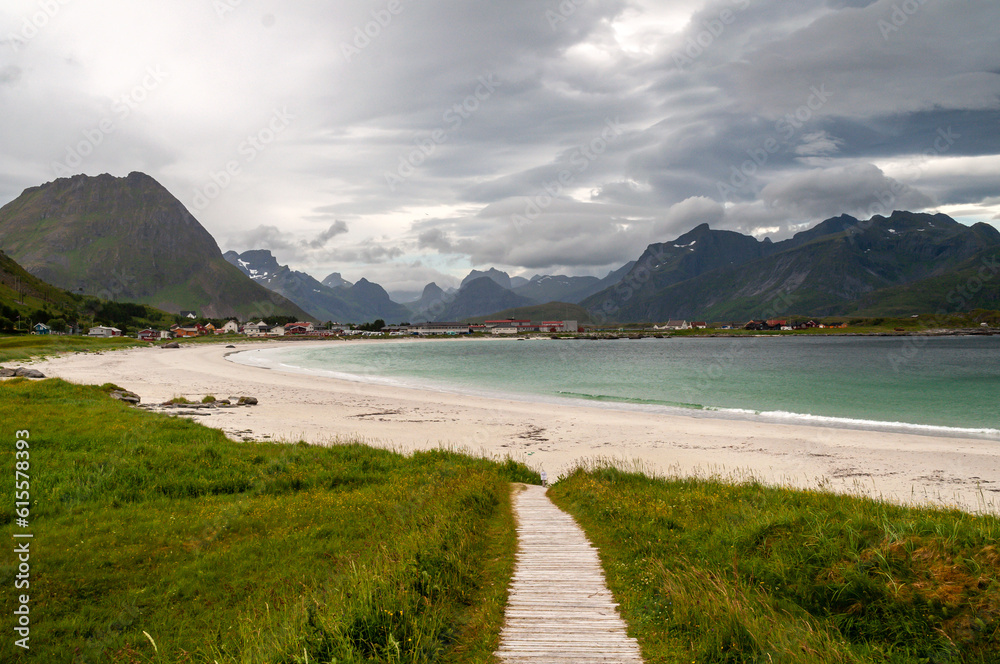 Sandy beach with path, sea bay with coast with mountains - Ramberg beach, Lofoten, Norway