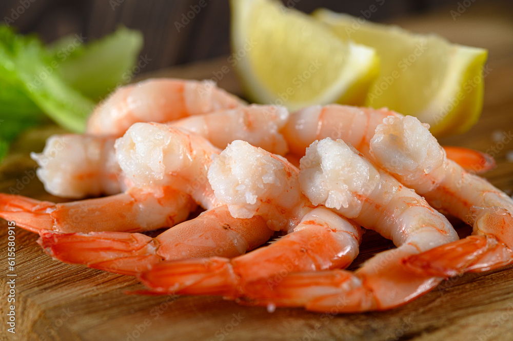 Close-up view of shrimps with lemon and green dill on wooden table Close-up view of shrimps with lemon and green dill on wooden table