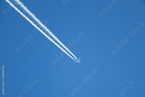 Jet contrails across the bright blue sky