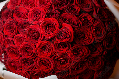 Close up view of large red roses bouquet in room interior. Happy st. valentine s day concept.