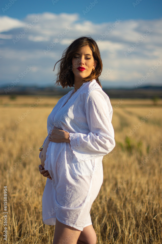 Young pregnant woman enjoying in countryside on a cloudy day Young pregnant woman enjoying in countryside on a cloudy day