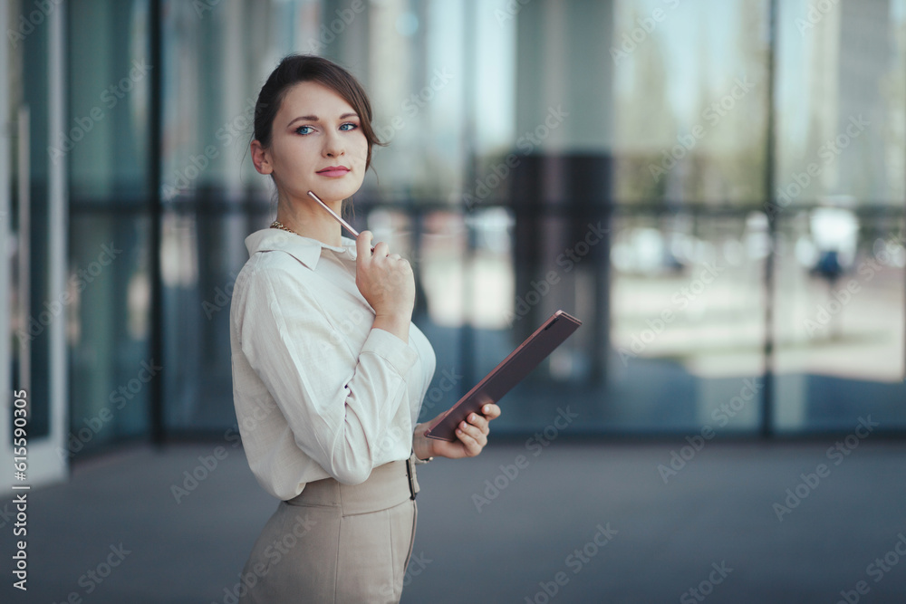 Young charming caucasian business woman with a tablet and a stylus in her hands thought about promising business projects.