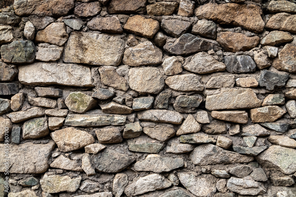 Old background of natural stones wall of different sizes.