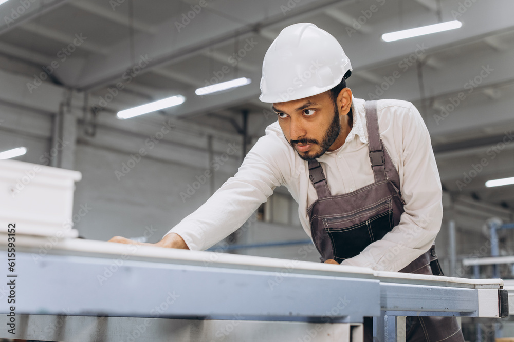 PVC industry worker making PVC frames for windows and doors PVC industry worker making PVC frames for windows and doors