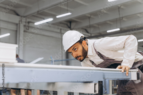 Wallpaper Mural PVC industry worker making PVC frames for windows and doors Torontodigital.ca