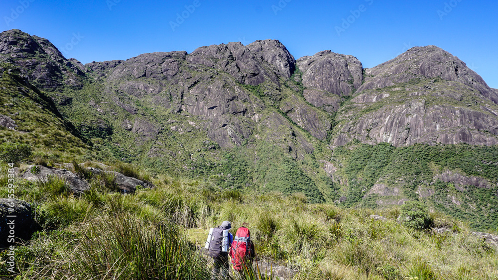 Trekkers towards Marins Peak, among the altitude vegetation