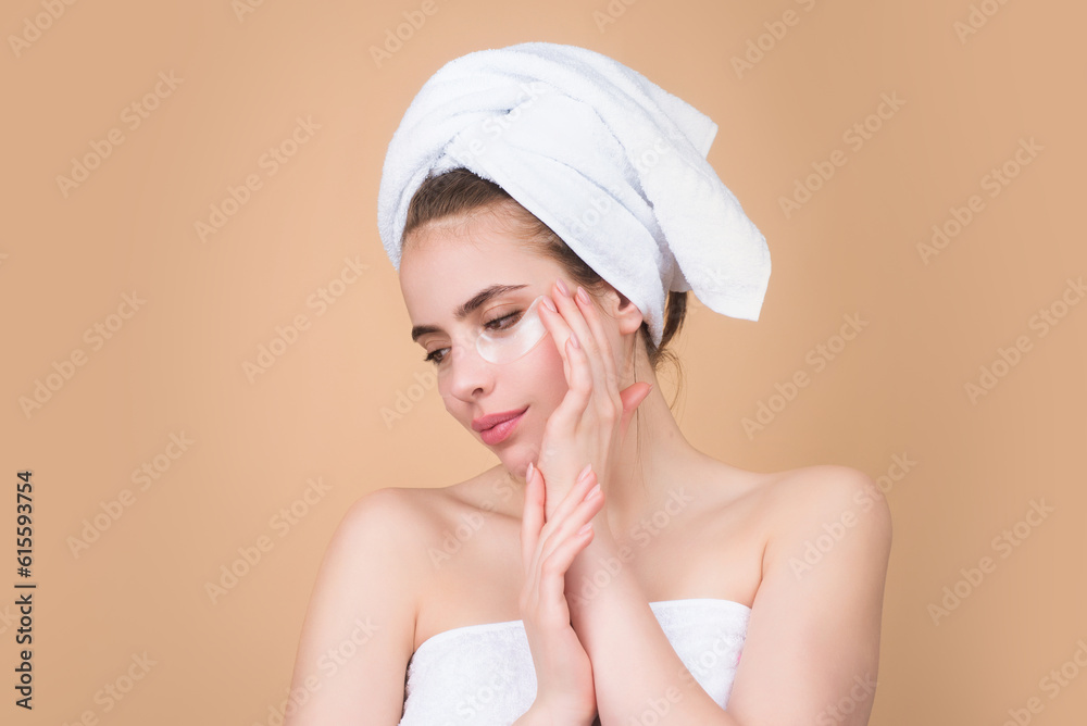Woman applying eye patches. Close up portrait of girl with collagen pad patches under eyes, taking care of delicate skin around eyes. Woman patches rejuvenation skin care.