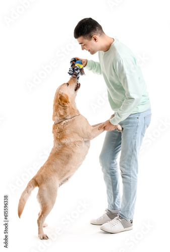 Young man playing with cute...