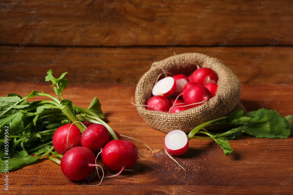 Bunch of ripe radish with green leaves on wooden background Bunch of ripe radish with green leaves on wooden background