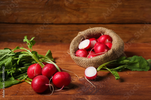 Bunch of ripe radish with green leaves on wooden background