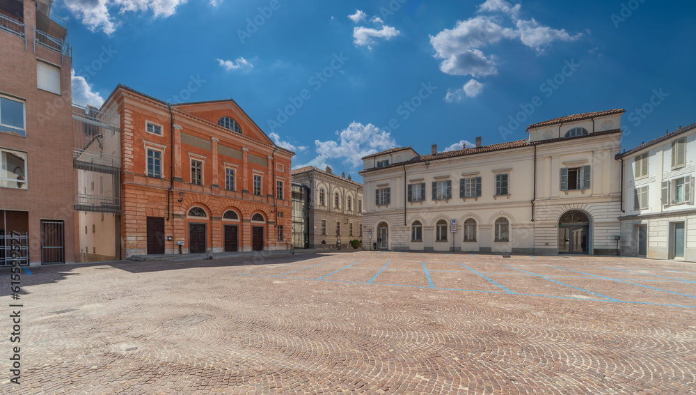 Alba, Langhe, Piedmont, Italy - August 16, 2022: cityscape of Vittorio Veneto cobblestone square with building of the Teatro Sociale (social theater) and ancient buildings
