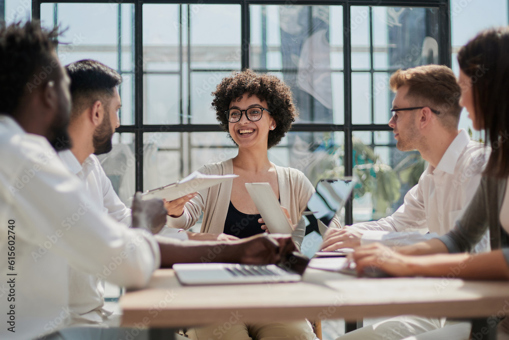Fototapeta premium Employees working at computer together, discussing content