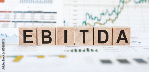 EBITDA - Earnings Before Interest, Taxes, Depreciation and Amortization. Business, financial, money investment profit concept on wooden cubes.