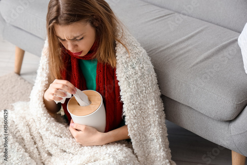 Young woman with cold sympt...