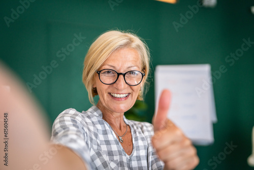 Portrait of one mature blonde caucasian woman with eyeglasses at home