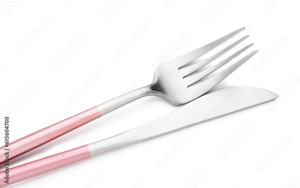 Stainless steel fork and knife with pink handles on white background Stainless steel fork and knife with pink handles on white background