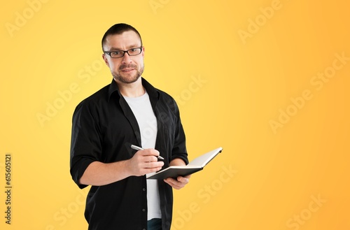 Young handsome man with notepad write business plan