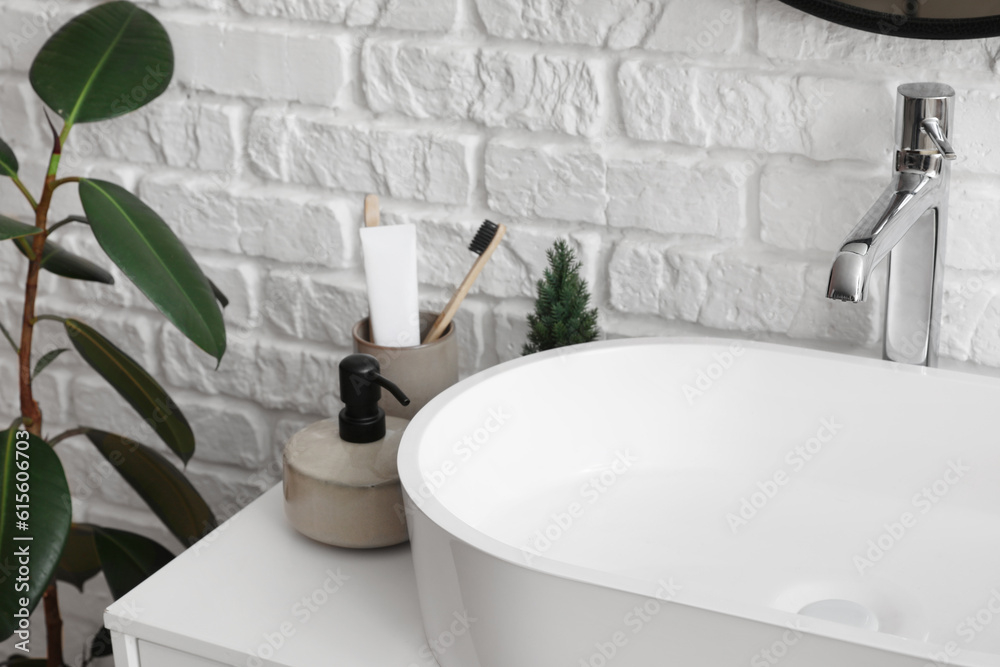 Fototapeta premium Sink bowl and bath accessories on table in bathroom, closeup