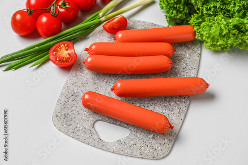 Raw red sausages on cutting...