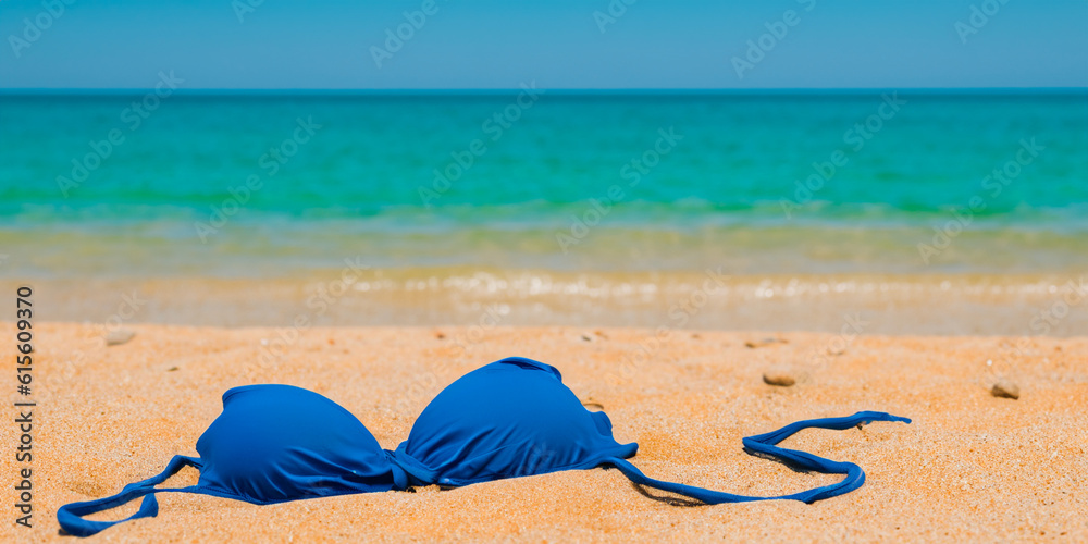Swimsuit in the sand on the seashore at the beach. Summer holidays concept. Relaxation and fun. Copy space for text. AI generative. Swimsuit in the sand on the seashore at the beach. Summer holidays concept. Relaxation and fun. Copy space for text. AI generative.