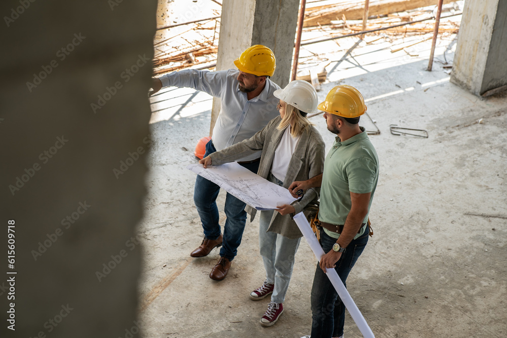 A female architect and construction manager work together on-site, discussing blueprints and coordinating to bring their project to life. A female architect and construction manager work together on-site, discussing blueprints and coordinating to bring their project to life.