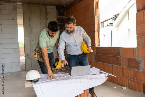 Two accomplished professionals, a male architect and a construction manager, collaborate on-site, leveraging their expertise to ensure seamless project execution and the realization of architectural e