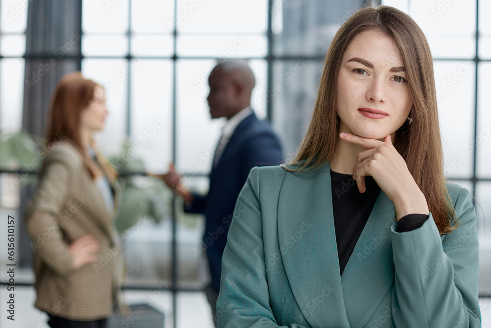Portrait of a confident young businesswoman standing with her arms crossed in an office Portrait of a confident young businesswoman standing with her arms crossed in an office