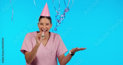 Birthday, party horn and balloons with a woman nurse in studio isolated on a blue background for celebration. Portrait, healthcare and a happy female medicine professional blowing on a noisemaker