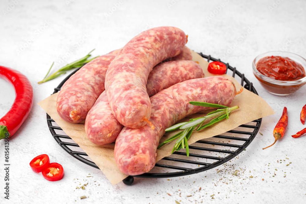 Grid with raw homemade sausages on light background Grid with raw homemade sausages on light background