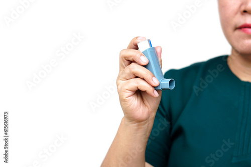 Close up woman hand holds asthma inhaler. Concept, health care. Pharmaceutical products for treatment symptoms of asthma or COPD. Use under prescription. Health care device at home. 