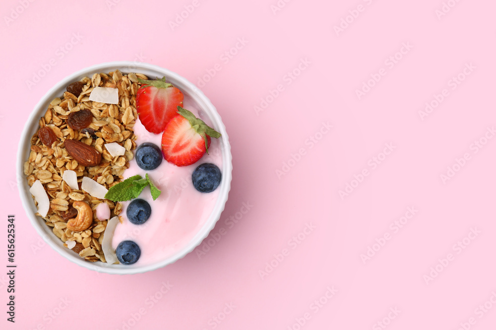 Tasty granola, yogurt and fresh berries in bowl on pink background, top view with space for text. Healthy breakfast Tasty granola, yogurt and fresh berries in bowl on pink background, top view with space for text. Healthy breakfast