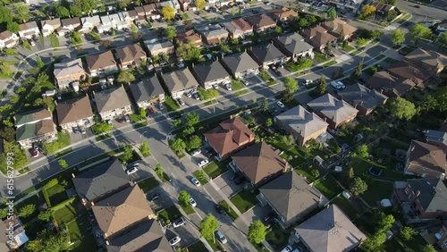 Aerial top down view of houses and streets in beautiful residential neighborhood in North America. Real estate, drone shots, sunset, sunlight. View from above on houses in Mississauga, Ontario Canada.