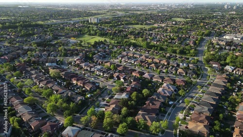 Aerial top down view of houses and streets in beautiful residential neighborhood in North America. Real estate, drone shots, sunset, sunlight. View from above on houses in Mississauga, Ontario Canada.