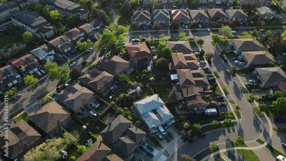 Aerial top down view of houses and streets in beautiful residential neighborhood in North America. Real estate, drone shots, sunset, sunlight. View from above on houses in Mississauga, Ontario Canada.