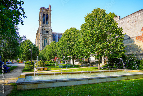 Water jets in the gardens of Mantoue Square outside the medieval basilica-cathedral of Soissons, dedicated to Saint Gervais and Saint Protais in the French Aisne department in Picardy, France photo