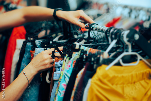 Hand of a Worker Arranging Clothes in a Fashion Store. Business owner working self-employed in a clothing boutique 