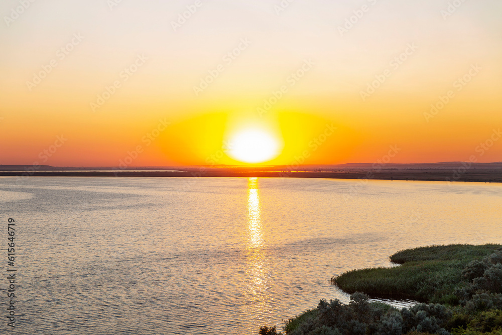 Gorgeous orange sunrise on the lake. Beautiful nature.