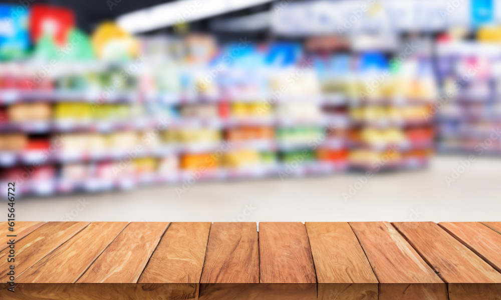 Wooden counter with blurred supermarket background. Table in the foreground for displaying products. Wooden counter with blurred supermarket background. Table in the foreground for displaying products.