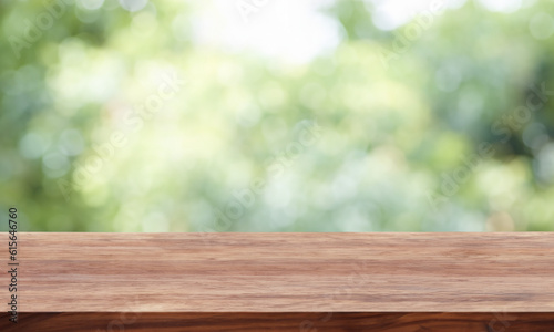 Wooden counter with blurred nature background. Table in the foreground for displaying products.