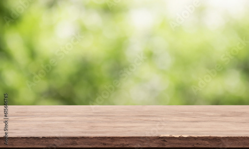 Wooden counter with blurred nature background. Table in the foreground for displaying products.