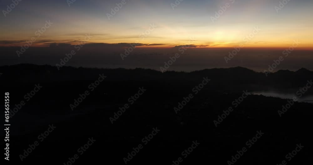 Tilt up shot of the sunrise on mount batur in bali, indonesia during the beautiful golden hour