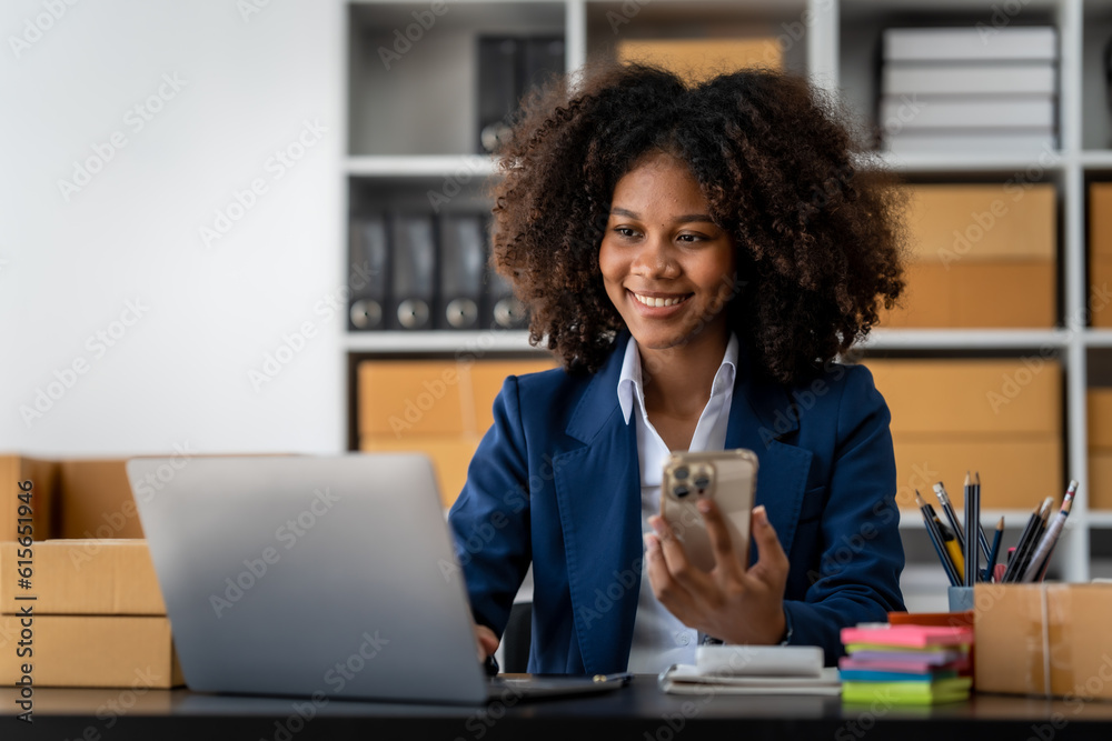 Pretty young african american woman startup freelancer business people is working at warehouse for online store. Pretty young african american woman startup freelancer business people is working at warehouse for online store.